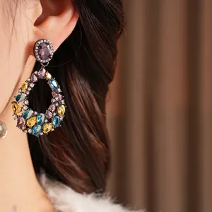 Vintage water drop earrings with colorful zircon inlay on model for luxury style