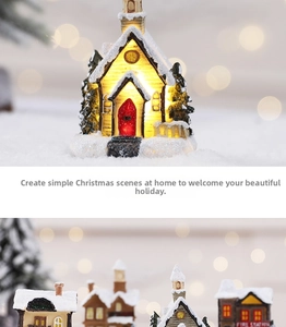 Macro shot of lighted resin Christmas house with faux snow and warm LED glow