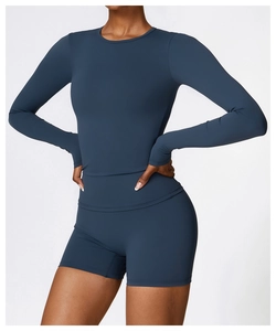 Detailed fit of blue-grey long sleeve athletic top and high waist compression shorts set