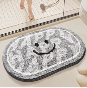 Close-up of a soft oval bath mat featuring a grey and white happy face pattern
