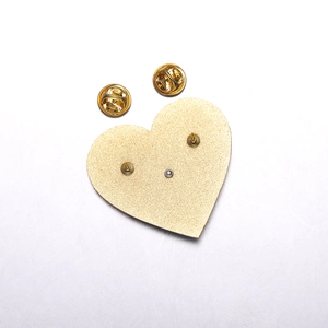 Detailed back view of gold heart brooch showing dual pin posts and butterfly clasps