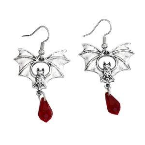 Detail of gothic silver bat earrings with vibrant red teardrop crystal pendants