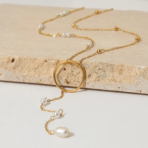 Elegant gold-tone Y-necklace with pearl accents and round pendant on stone base