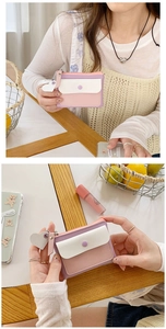 Detail of macaron tricolor PU leather wallet with heart pendant and secure zipper closure