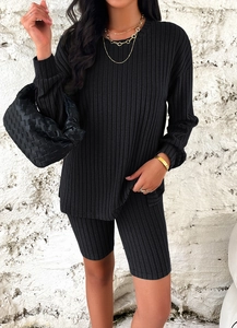 Close-up of black ribbed knit lounge set featuring long sleeve top and matching shorts