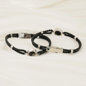 Braided leather bracelets with stainless steel anchor clasp and compass charm on fabric