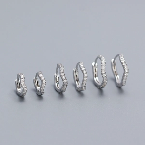 Detailed view of three graduated sizes of S925 silver wavy hoop earrings with pavé diamonds