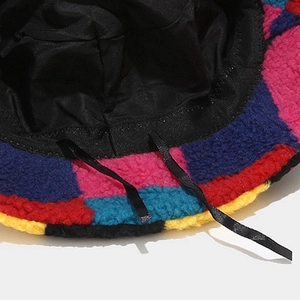 Close-up of lamb wool bucket hat interior featuring black lining and adjustable drawstring