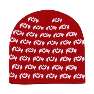 Close-up detail of the red and white jacquard knit pattern on the winter beanie hat