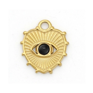 Detailed close-up of a golden heart pendant with a black evil eye stone and starburst lines