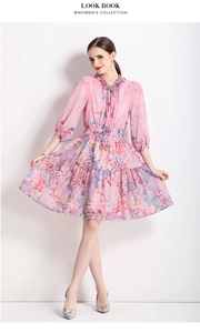 Detail of pink floral chiffon dress with ruffled collar and tie-neck lantern sleeves