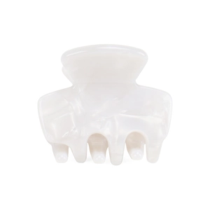 Macro view of white acetate hair claw with glossy marble texture and geometric design