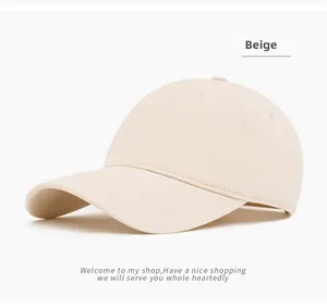 Close-up of beige cotton baseball cap featuring six-panel construction and eyelets
