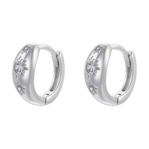 Macro detail of silver stud earrings featuring sparkling sunburst star cubic zirconia