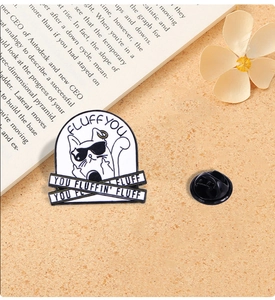 Detailed view of a white cartoon cat enamel pin with sunglasses and black rubber clutch
