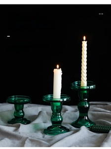 Set of three vintage green glass candle holders in different heights for home decor
