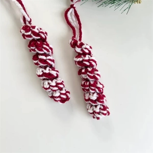 Handcrafted red and white spiral knitted Christmas ornaments for holiday tree decoration