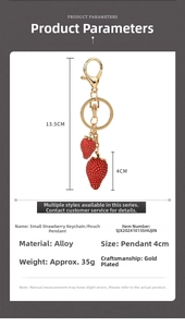 Detailed view of red double strawberry keychain with gold-plated alloy charm and dimensions