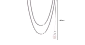 Detailed close-up of double-layer silver snake chain with 19cm pearl pendant drop