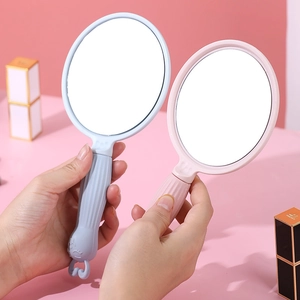 Portable handheld makeup mirror with cartoon handle in light pink and blue finishes