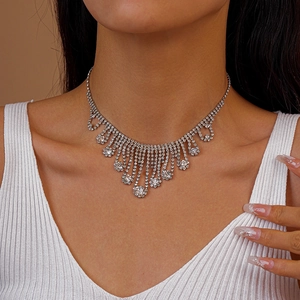 Detail of silver layered tassel necklace with pavé-set rhinestones on a female model
