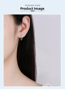 Detail view of s925 silver hoop earring with pavé diamonds on model ear