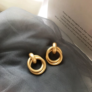 Modern matte gold overlapping double hoop earrings with a textured frosted finish
