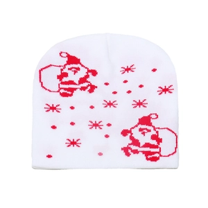 Detail of white knit beanie showing red Santa Claus and snowflake jacquard patterns