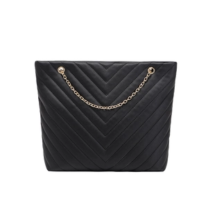 Chic black V-quilted leather tote bag with gold chain strap on white background
