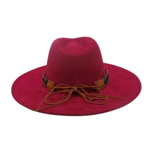 Detail of fuchsia fedora hat with colorful ethnic woven band and brown leather tie decoration