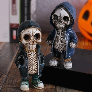 Gothic skull figurines in street hoodies on black stand with Halloween pumpkin background