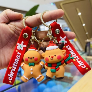 Close-up of gingerbread man and reindeer Christmas keychains with red festive wristlets