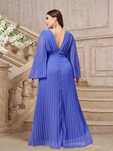 Detail of dark purple pleated maxi dress featuring deep V-neck and flared sleeves