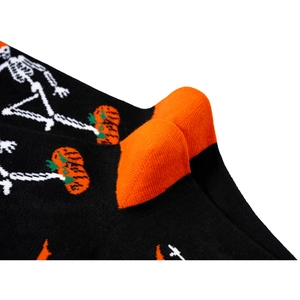 Detail shot of Halloween socks with skull and pumpkin patterns showing heel stitching