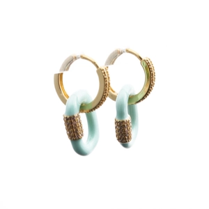 Detail view of mint green enamel star earrings with gold plating and zircon accents