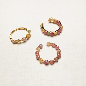 Detailed wire-wrapped 14K gold ring and ear cuffs with pink yellow and green gemstone beads