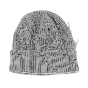 Detail shot of a grey distressed knit beanie with street style shredded fringe edges