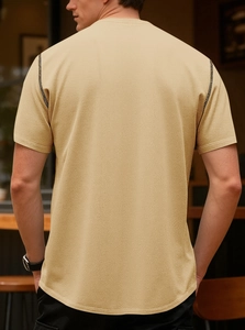 Detailed back view of men's polo shirt featuring mesh knit texture and contrast stitching