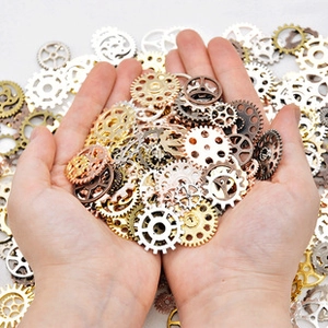 Close-up of assorted vintage metal gears in gold, silver, and bronze for DIY crafts