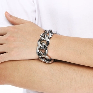 Close-up of 30mm wide silver polished stainless steel Cuban link chain on wrist