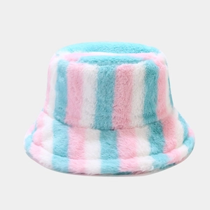Detail of colorful rainbow striped plush bucket hat with soft pastel pink and blue textures