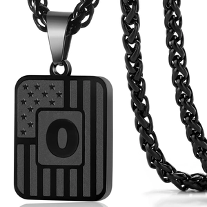 Detail shot of matte black military dog tag necklace featuring star patterns and letter O