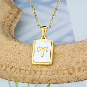 Macro view of Aries zodiac square pendant with white shell inlay and gold-tone frame