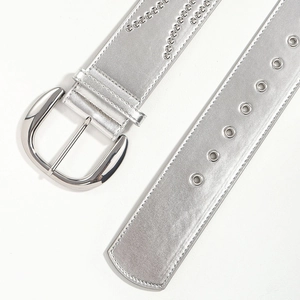 Detail of silver studded belt with vintage buckle and rivets on premium faux leather