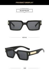 Detail view of vintage square sunglasses with black frames and golden arrow accents