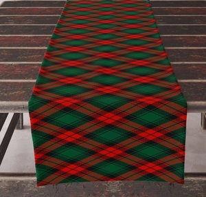 Detailed texture of red and green tartan plaid linen table runner on rustic wood