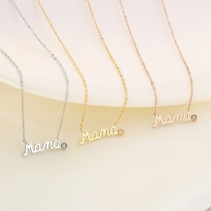 Three elegant Mama pendant necklaces in silver, gold, and rose gold with small diamonds