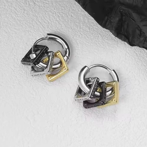 Macro shot of silver hoops with square pendants featuring LOVE engraving in three colors