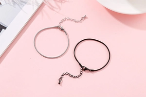 Detail view of silver and black snake bone bracelets with adjustable lobster clasp