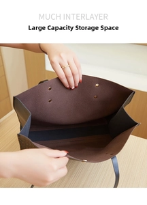 Detail view of large tote bag interior showing multiple interlayers and deep brown lining